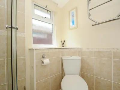 a bathroom with a toilet and a window at Little Trebah in St Merryn