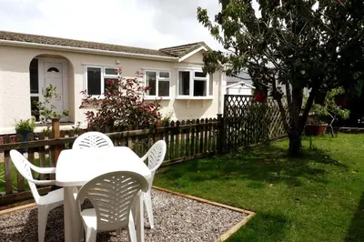 a table and chairs in the yard of a house at Parc Trethias in St Merryn