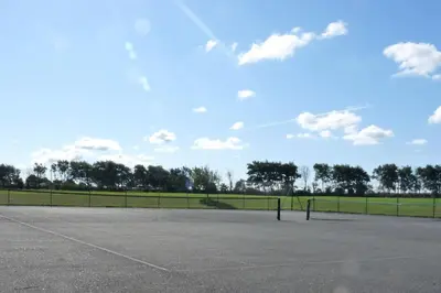 an empty parking lot with a field in the background at Parc Trethias in St Merryn