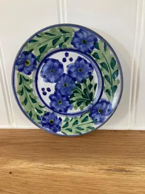 a blue and white plate with blue flowers on it at Spacious flat St Ives former farmhouse, parking in St Ives