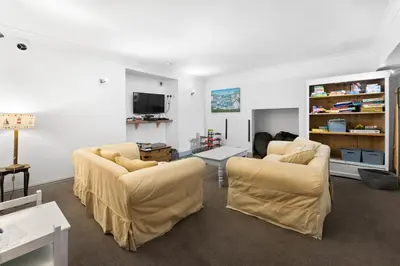 a living room with two couches and a tv at The Rosevine in Porthscatho