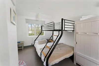 a small bedroom with a bunk bed and a bunk bedouble at The Rosevine in Porthscatho