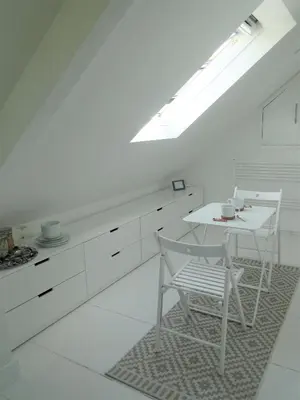 a white kitchen with a white table and chairs at Private Double Room and Ensuite in Historic Cornish Cottage in Helston