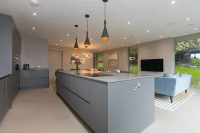 an open kitchen with a large island with a sink at Sparrows Nest in St Ives