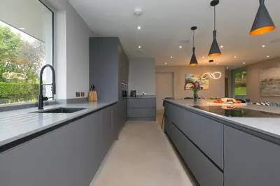 a kitchen with a long counter and a sink at Sparrows Nest in St Ives