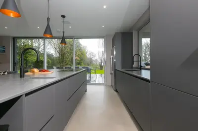 a kitchen with black and white counters and a window at Sparrows Nest in St Ives