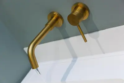 a brass shower head on a wall in a bathroom at Sparrows Nest in St Ives