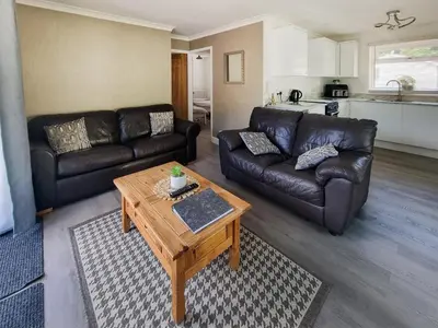 a living room with a couch and a coffee table at Squirrels Leap in Saint Cleer
