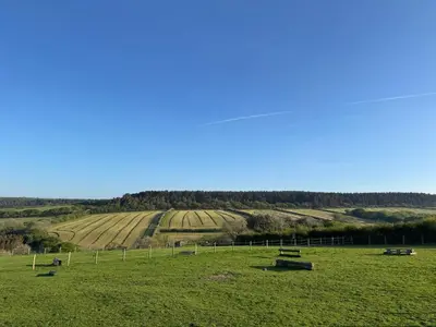 a field with benches in the middle of a field at The Old Stable Block - Flat 2 in Wadebridge