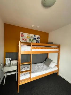 a bunk bedded room with two bunk beds in a room at Elemental Surf Lodge in Newquay