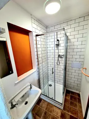 a bathroom with a sink and a shower at Elemental Surf Lodge in Newquay