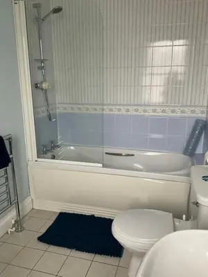 a bathroom with a tub and a toilet and a sink at No 52 bed and breakfast in Helston