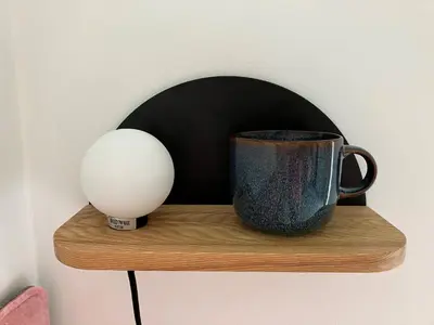 a coffee cup and a egg on a wooden shelf at 2a Coastguard Cottages in Gorran Haven