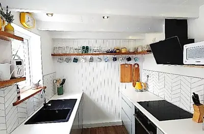 a white kitchen with a sink and a microwave at 3 Bed in Porthleven oc-12bayv in Porthleven