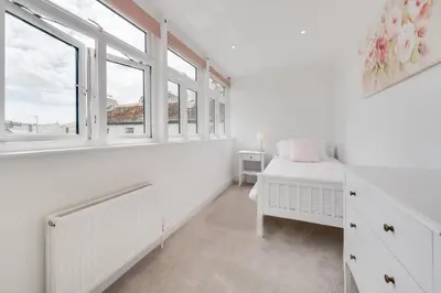 a bedroom with white walls and windows and a bed at 3 Bed in Fowey oc-1cobbs in Fowey