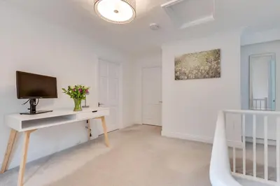 a living room with a tv and a desk at 3 Bed in Fowey oc-1cobbs in Fowey