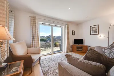 a living room with a couch and a chair and a window at 2 Bed in Porthleven oc-1mont in Porthleven