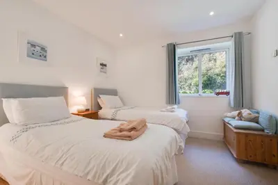 a bedroom with two beds and a window at 2 Bed in Porthleven oc-1mont in Porthleven