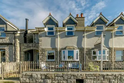 a large house with a fence in front of it at 3 Bed in Porthleven oc-1seav in Porthleven