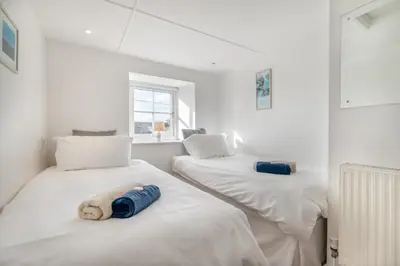 two beds with a teddy bear on them in a room at 2 Bed in Rinsey oc-2chapl in Praa Sands