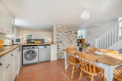 a kitchen with a table and a dining room at 2 Bed in Rinsey oc-2chapl in Praa Sands