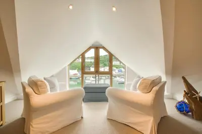 a living room with two chairs and a window at 2 Bed in Porthleven oc-4stelv in Porthleven