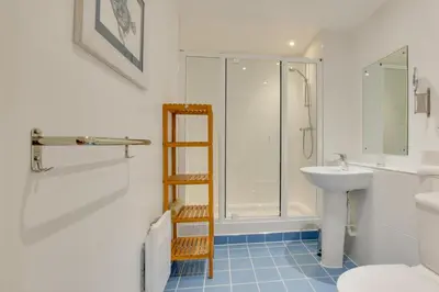 a bathroom with a shower and a toilet and a sink at 2 Bed in Porthleven oc-4stelv in Porthleven