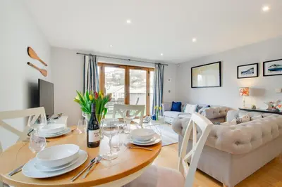 a dining room and living room with a table and chairs at 2 Bed in Looe oc-6creek in Looe