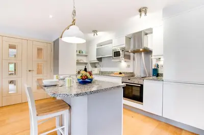 a kitchen with white cabinets and a counter top at 2 Bed in Looe oc-6creek in Looe