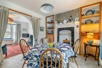 a dining room with a table and a fireplace at 3 Bed in Porthleven oc-7bayvi in Porthleven