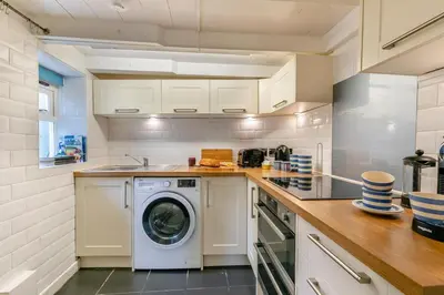 a kitchen with a washing machine and a sink at 3 Bed in Porthleven oc-7bayvi in Porthleven