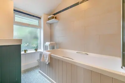 a bathroom with a large tub and a window at 3 Bed in Porthleven oc-7bayvi in Porthleven