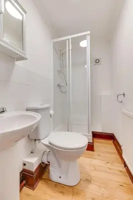 a white bathroom with a toilet and a shower at 3 Bed in Falmouth oc-anchge in Falmouth