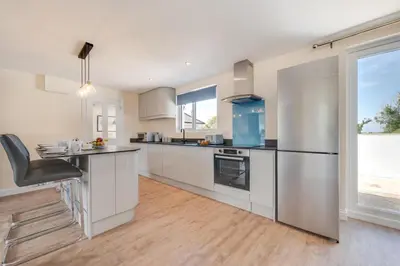 a kitchen with stainless steel appliances and a window at 3 Bed in Higher Crackington oc-avond in Crackington Haven