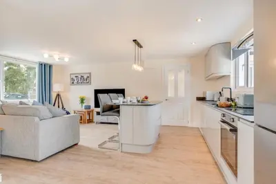 a kitchen and living room with a couch and a table at 3 Bed in Higher Crackington oc-avond in Crackington Haven