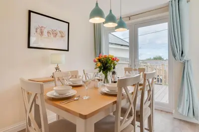 a dining room with a wooden table and chairs at 3 Bed in Higher Crackington oc-avond in Crackington Haven