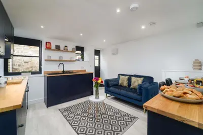 a kitchen and living room with a bowl of bread at Little Burrows in St Ives