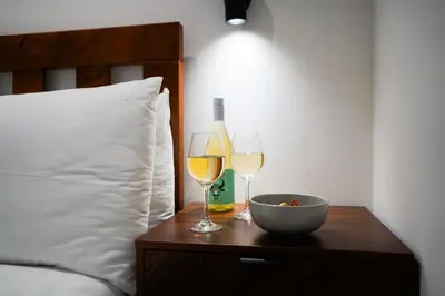 a table with two glasses and a bowl and bottle of wine at Little Burrows in St Ives