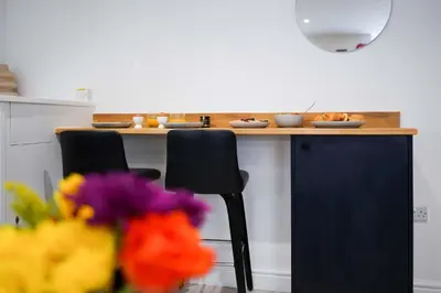 a kitchen with a counter with plates of food on it at Little Burrows in St Ives