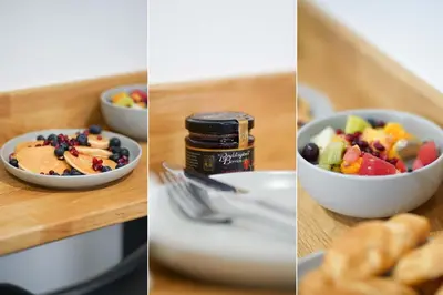 a table with a bowl of fruit and a bowl of food at Little Burrows in St Ives