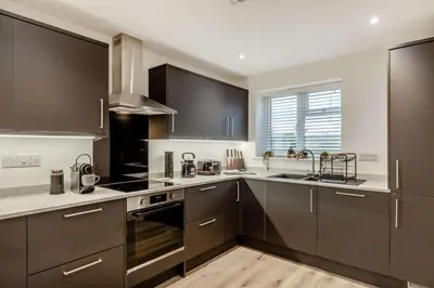 a kitchen with black and white appliances and a window at 3 Bed in Penrose oc-butcup in Saint Ervan