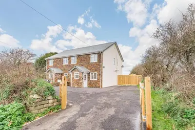 a brick house with a gate on a road at 3 Bed in Penrose oc-butcup in Saint Ervan