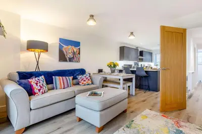 a living room with a couch and a table at 3 Bed in Penrose oc-butcup in Saint Ervan