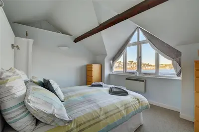 a bedroom with a bed and a large window at 2 Bed in Fowey oc-ccgree in Fowey