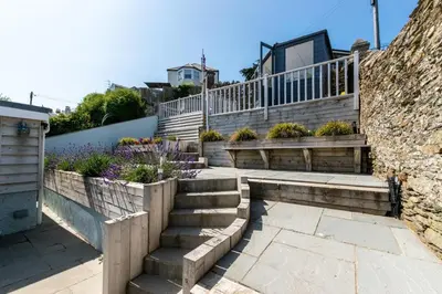 a set of stairs with a stone wall at 2 Bed in Fowey oc-ccgree in Fowey