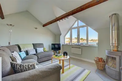 a living room with a couch and a fireplace at 2 Bed in Fowey oc-ccgree in Fowey