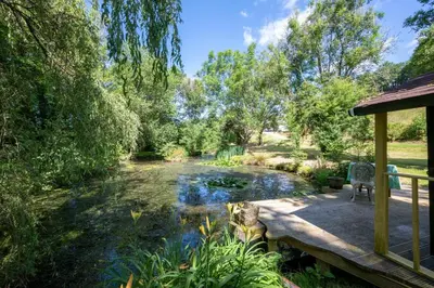 a garden with a pond and a wooden deck at 1 Bed in Trehunist oc-chretr in Quethiock