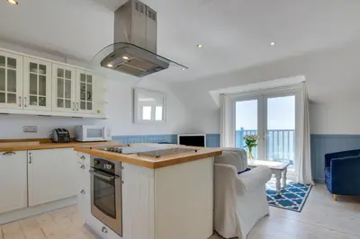 a kitchen with white cabinets and a counter top at 2 Bed in Porthleven oc-clifto in Porthleven