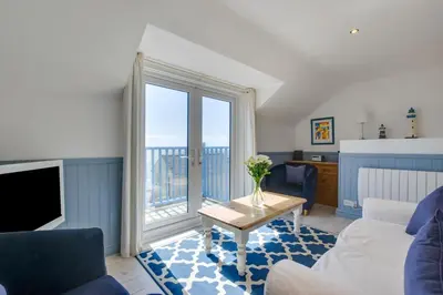 a living room with a couch and a table at 2 Bed in Porthleven oc-clifto in Porthleven