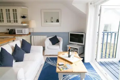 a living room with a white couch and a tv at 2 Bed in Porthleven oc-clifto in Porthleven